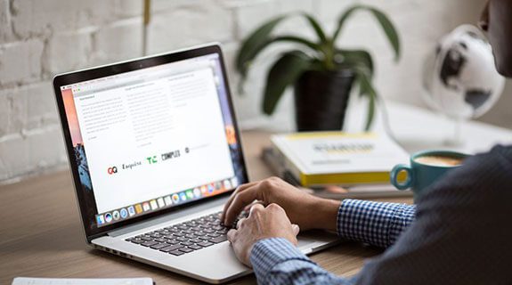 Should Your Business Invest In A New Website? Man typing on laptop